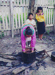 Artisan dying cloth over fire