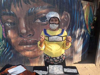 Shipibo Woman Showing the Face Mask that She Made<br>Handmade by Indigenous Shipibo Women of the Peruvian Rainforest