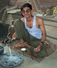 Mohd Shakeel works on a project with a blow torch Mohd Shakeel works on a project with a blow torch