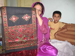 Baknazira Showing Embroidered Scarf made by Khabar e Khosh in Afghanistan. Baknazira Showing Embroidered Scarf made by Khabar e Khosh in Afghanistan.