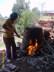 Ceramic artisan from Quinua Peru firing the ceramic kiln